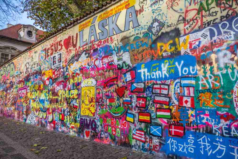 Challenge your mind and spirit at the John Lennon Wall, an outdoor escape game steeped in artistic expression and messages of hope.
