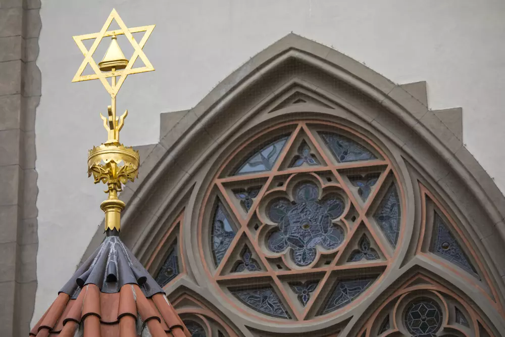 Vitráže v oknech Maiselovy synagogy v Praze, zobrazující biblické motivy a symboly.