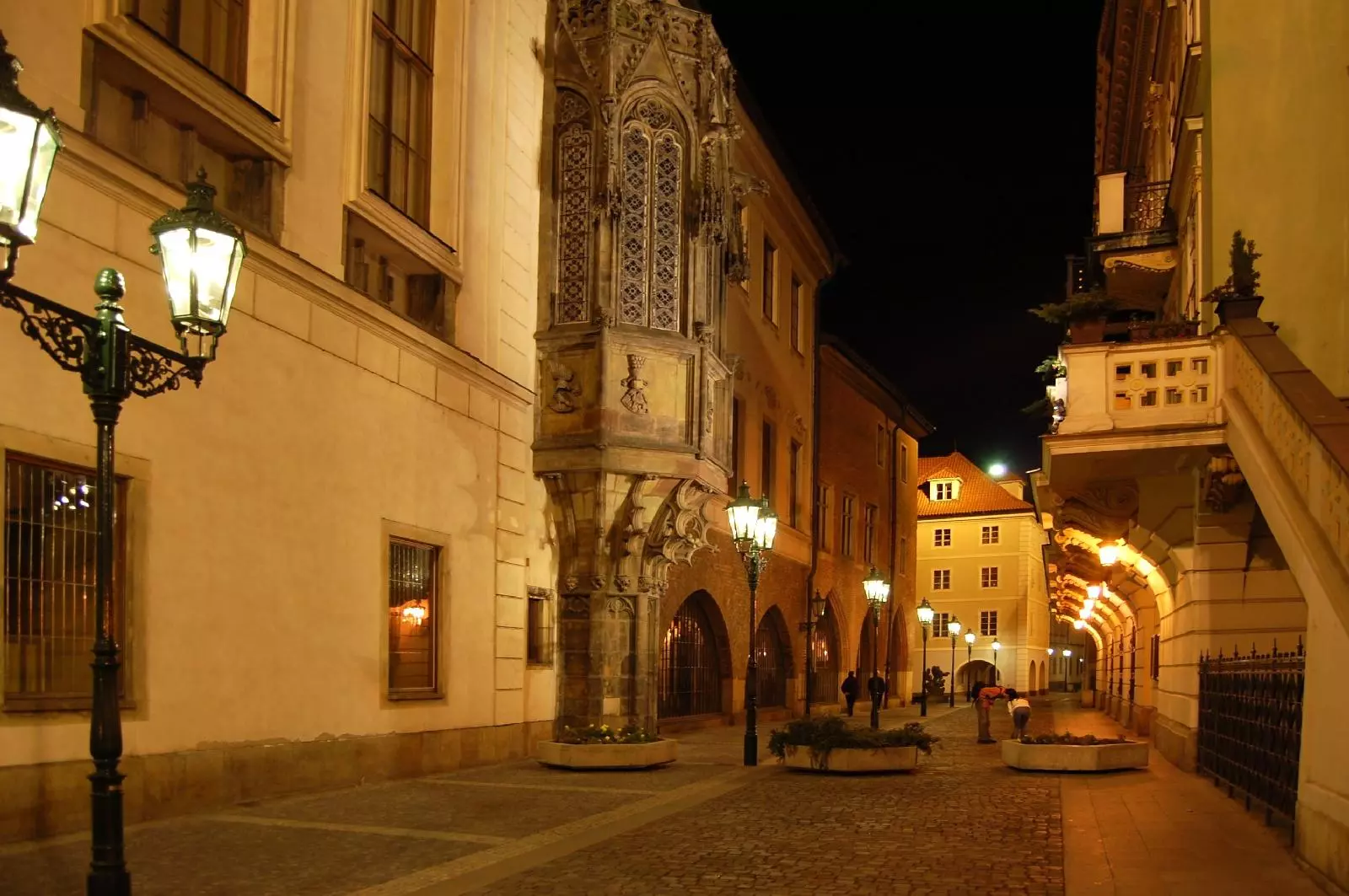 Night view of the Karolinum in Prague with historical lighting and surrounding buildings