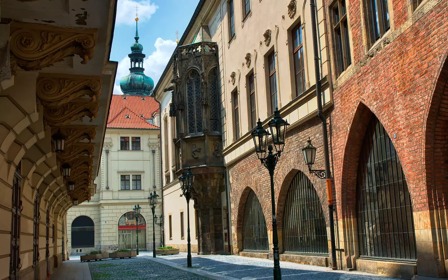 Karolinum in Prague during daylight with historical buildings and street lamps